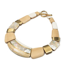 Load image into Gallery viewer, Necklace of different shaped white wooden segments inlaid with mother of pearl and abalone shell and brass