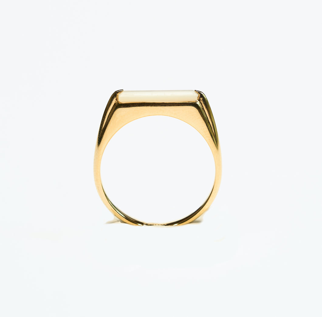 rectangular slice of Mother of Pearl set into 18k gold plated, recycled silver ring on white background