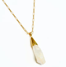 Load image into Gallery viewer, Gold chain necklace with a raw rock crystal pendant on a white background

